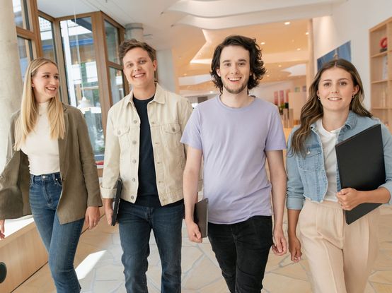 Vier Nachwuchs-Fachkräfte im im Flur im dm-Unternehmenssitz